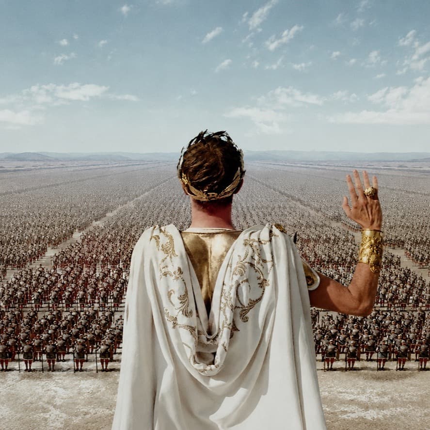 A laurel-crowned Roman ruler seen from behind, raising a hand to a vast army stretching to the horizon