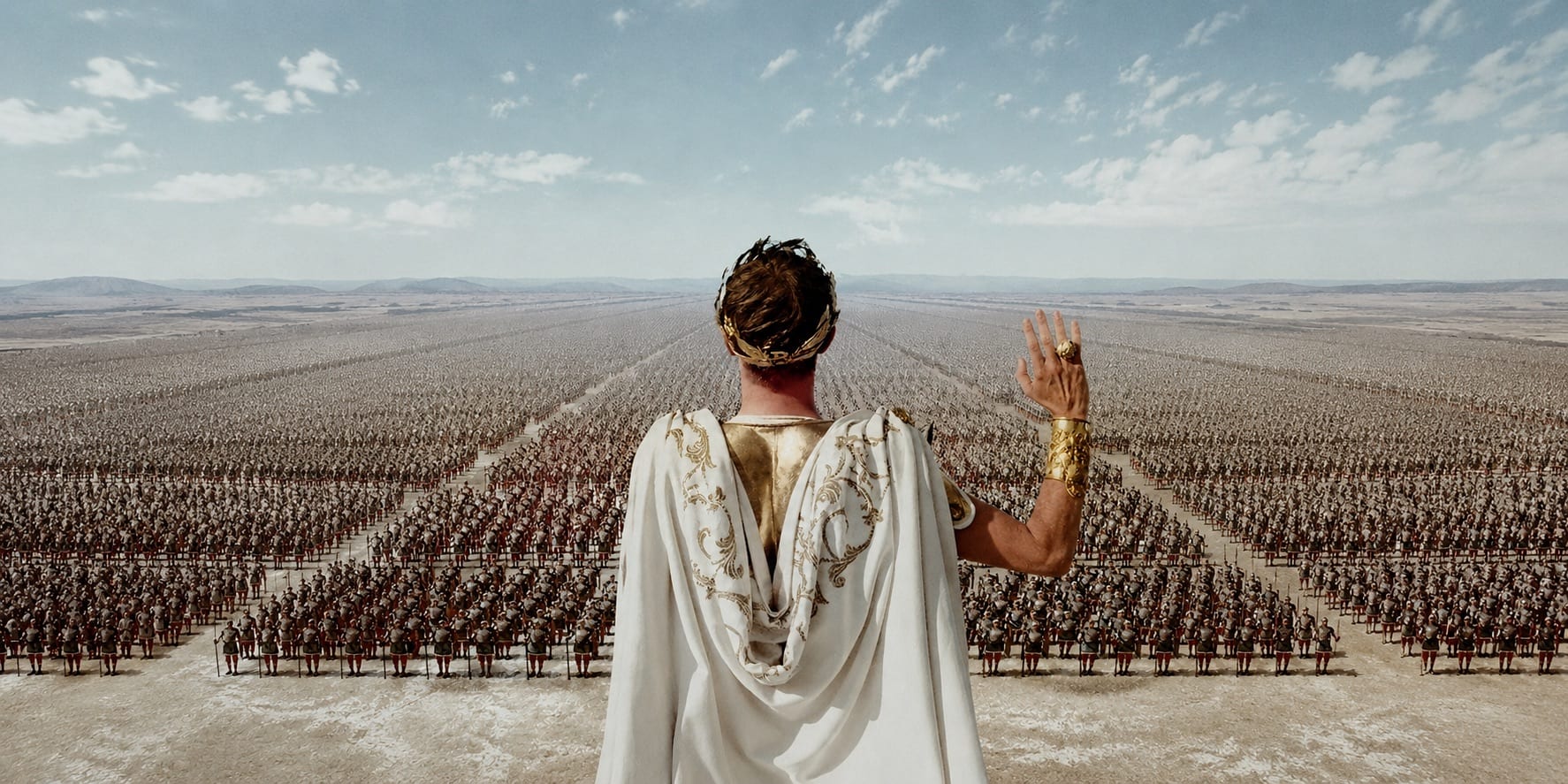 A laurel-crowned Roman ruler seen from behind, raising a hand to a vast army stretching to the horizon